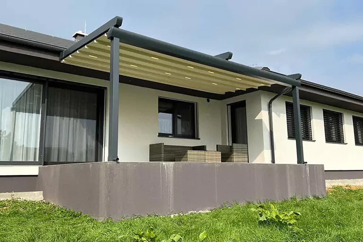 Retractable roof pergola on the terrace of a single-storey house