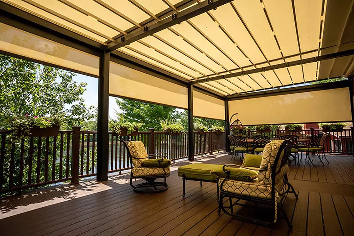Retractable fabric roof pergola over a timber deck with lounge seating underneath