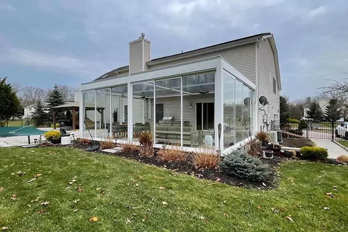 White-framed glass winter garden added to the side of a house