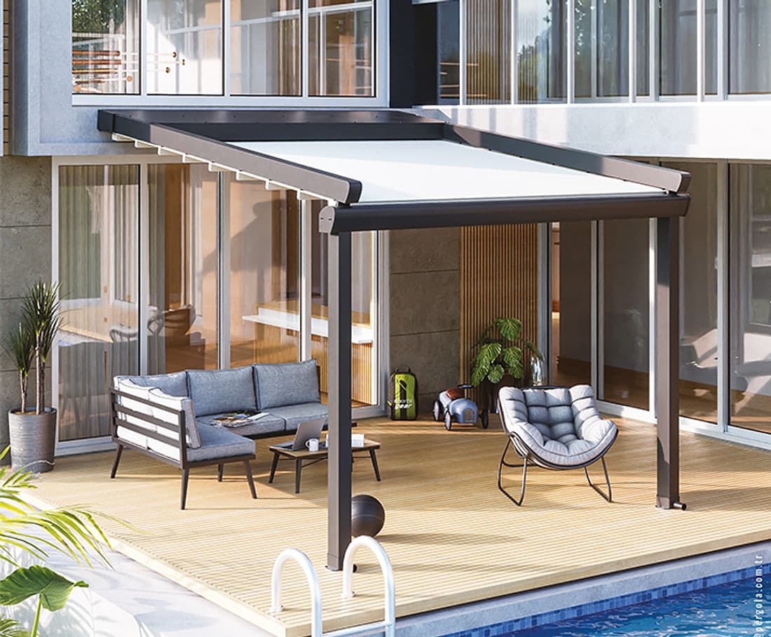 Elegant retractable roof pergola, wall-mounted over a timber deck with a sofa and chair beside a pool